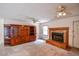 Cozy living room featuring a fireplace, tile hearth, and built in shelving at 3223 Heritage Way, Buford, GA 30519