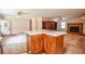 Spacious living room with a fireplace, built-in shelving, and large island with a breakfast bar at 3223 Heritage Way, Buford, GA 30519