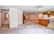 Open living space with a kitchen, fireplace, and access to bathroom at 3223 Heritage Way, Buford, GA 30519