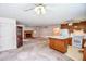 Expansive living room featuring a kitchen, fireplace, and hardwood bookcase at 3223 Heritage Way, Buford, GA 30519