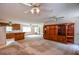Spacious living room featuring a large wood entertainment center and ceiling fans at 3223 Heritage Way, Buford, GA 30519