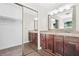 Spacious bathroom with double vanity, wood cabinets, and large walk-in closet at 998 Pointer Rdg, Tucker, GA 30084
