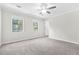 Spacious carpeted bedroom with natural lighting from large windows at 998 Pointer Rdg, Tucker, GA 30084