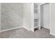 Bedroom featuring plush carpet, neutral colored walls and built in closet system at 998 Pointer Rdg, Tucker, GA 30084