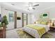 Well-lit bedroom features a ceiling fan, carpet, and two large windows at 998 Pointer Rdg, Tucker, GA 30084