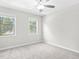 Bright bedroom with plush carpet, ceiling fan, and double hung windows at 998 Pointer Rdg, Tucker, GA 30084