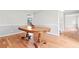 Dining room with hardwood floors and a wooden table, with view to staircase and hallway at 998 Pointer Rdg, Tucker, GA 30084