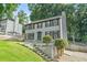 Classic two-story home with green front door, set on a landscaped lot with mature trees and a driveway at 998 Pointer Rdg, Tucker, GA 30084