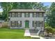 Charming two-story home with a well-manicured front yard, gray siding and dark shutters and a bright green door at 998 Pointer Rdg, Tucker, GA 30084