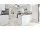 Kitchen with tile floors, white cabinets, stainless appliances, and island at 998 Pointer Rdg, Tucker, GA 30084