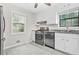 Kitchen view showing stainless steel appliances, granite countertops, and white cabinets at 998 Pointer Rdg, Tucker, GA 30084