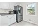Kitchen view showing stainless steel refrigerator, microwave and granite counters at 998 Pointer Rdg, Tucker, GA 30084