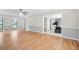 Open floor plan with hardwood flooring, light gray wall paneling, a view to the kitchen, and natural light at 998 Pointer Rdg, Tucker, GA 30084