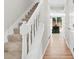 Bright foyer featuring a staircase with white railing, hardwood floors, and view to the living area at 998 Pointer Rdg, Tucker, GA 30084