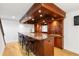 Basement bar area with custom wood finishes, granite countertops, and seating for seven at 1515 Lockridge Dr, Cumming, GA 30041