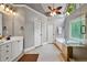 Bathroom featuring a double vanity, tile floors, soaking tub, walk-in shower, and neutral paint at 1515 Lockridge Dr, Cumming, GA 30041
