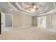 Spacious bedroom with neutral paint colors, tray ceiling and carpet floors at 1515 Lockridge Dr, Cumming, GA 30041