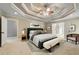 Spacious bedroom with neutral paint colors, tray ceiling and an ensuite bathroom at 1515 Lockridge Dr, Cumming, GA 30041