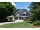 Beautiful two-story home with a well-manicured lawn, attached garage, and inviting curb appeal at 1515 Lockridge Dr, Cumming, GA 30041