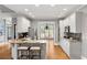 Bright, open kitchen featuring white cabinets, granite countertops, and stainless steel appliances at 1515 Lockridge Dr, Cumming, GA 30041