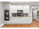 Modern kitchen with white cabinets, stainless steel appliances, and stylish backsplash design at 1515 Lockridge Dr, Cumming, GA 30041