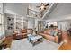 Spacious living room featuring hardwood floors, a staircase, and built-in shelving at 1515 Lockridge Dr, Cumming, GA 30041
