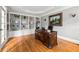 Home office featuring hardwood floors, custom built-ins, desk, and neutral paint colors at 1515 Lockridge Dr, Cumming, GA 30041