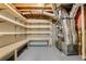 Basement with built-in shelves and workbench, featuring exposed ductwork and utility equipment at 1548 Valley Reserve Court, Kennesaw, GA 30152