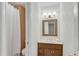 A bathroom featuring a shower with curtain, a vanity with sink, and a decorative mirror at 1548 Valley Reserve Court, Kennesaw, GA 30152