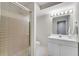 Well-lit bathroom with glass-door shower, white vanity, and neutral tile at 1548 Valley Reserve Court, Kennesaw, GA 30152
