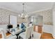 Elegant dining room with hardwood floors, glass table, and floral wallpaper at 1548 Valley Reserve Court, Kennesaw, GA 30152