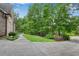 Long driveway of a brick home with mature trees and greenery at 1548 Valley Reserve Court, Kennesaw, GA 30152