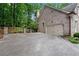 Image of a driveway leading to an attached garage with brick architecture at 1548 Valley Reserve Court, Kennesaw, GA 30152