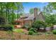 Exterior showcasing a backyard with a deck, pergola, lush landscaping, and brick architecture at 1548 Valley Reserve Court, Kennesaw, GA 30152