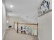 Second story hallway overlooking the living room with neutral paint and plush carpeting at 1548 Valley Reserve Court, Kennesaw, GA 30152