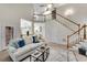 Inviting living room with vaulted ceilings and staircase has lots of natural light and space for entertaining at 1548 Valley Reserve Court, Kennesaw, GA 30152