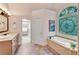 Bright ensuite bathroom with garden tub and walk-in closet access at 1548 Valley Reserve Court, Kennesaw, GA 30152