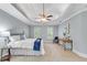 Bright primary bedroom featuring tray ceilings, carpeting, and modern furniture at 1548 Valley Reserve Court, Kennesaw, GA 30152