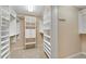 Walk-in closet with custom shelving and storage, carpeted flooring and recessed lighting at 1548 Valley Reserve Court, Kennesaw, GA 30152