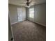 Bedroom featuring neutral carpet, a window, and a ceiling fan at 170 Inverness Trce, Riverdale, GA 30274