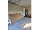 Spacious garage area with concrete floor, water heater, and overhead door at 170 Inverness Trce, Riverdale, GA 30274