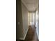 Hallway with hardwood flooring with multiple doorways at 170 Inverness Trce, Riverdale, GA 30274