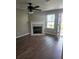 Living room features a fireplace, neutral colored walls, and wood-look laminate flooring at 170 Inverness Trce, Riverdale, GA 30274