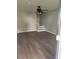 Shot of empty living room with staircase, neutral wall color, and wood-look laminate flooring at 170 Inverness Trce, Riverdale, GA 30274