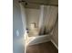 Bathroom view shows shower stall with updated fixture and wood-look laminate flooring at 170 Inverness Trce, Riverdale, GA 30274