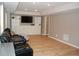 Finished basement with wood floors, a reclining leather sofa, and custom built-in storage at 3145 Sweet Basil Ln, Loganville, GA 30052