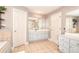 Inviting bathroom with a soaking tub, a double sink vanity, and tiled floors, designed for relaxation and convenience at 3145 Sweet Basil Ln, Loganville, GA 30052