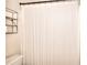 Bathroom features a shower with a white patterned shower curtain and black metal shelving at 3145 Sweet Basil Ln, Loganville, GA 30052