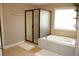 Relaxing bathroom featuring a large bathtub, walk-in shower, and tile floors for a spa-like experience at 3145 Sweet Basil Ln, Loganville, GA 30052
