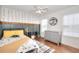 Bedroom features decorative walls, hardwood floors, and a ceiling fan at 3145 Sweet Basil Ln, Loganville, GA 30052